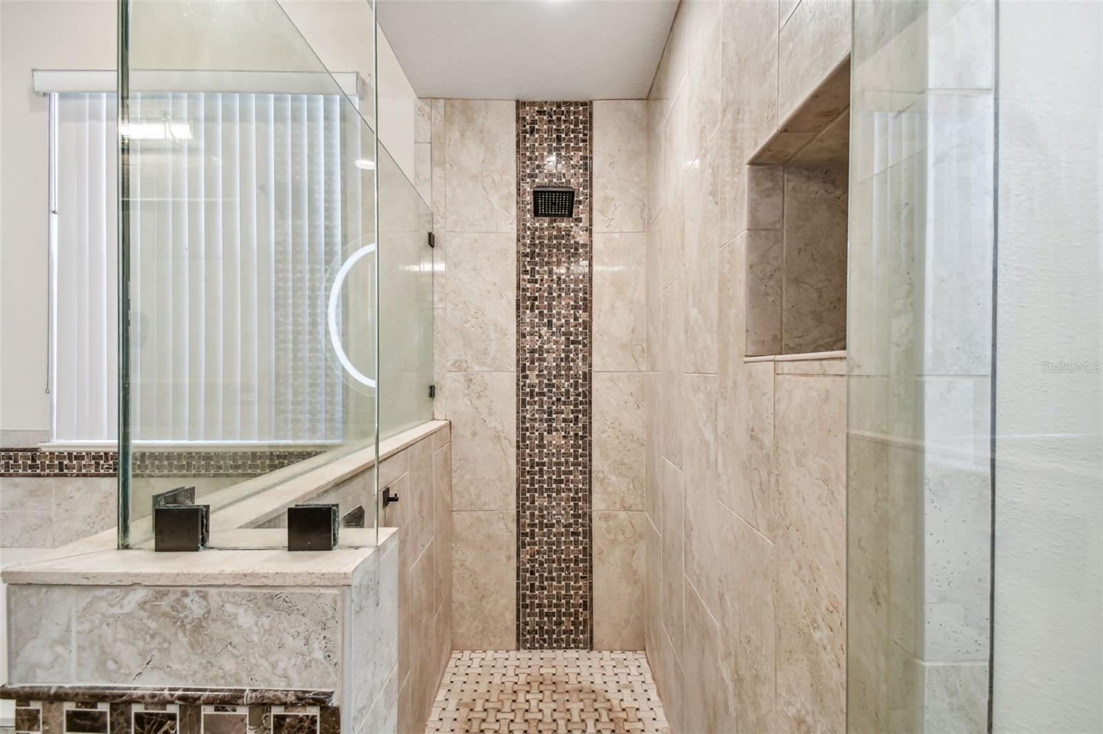 This oversized walk in shower is decorated with coordinating tile.