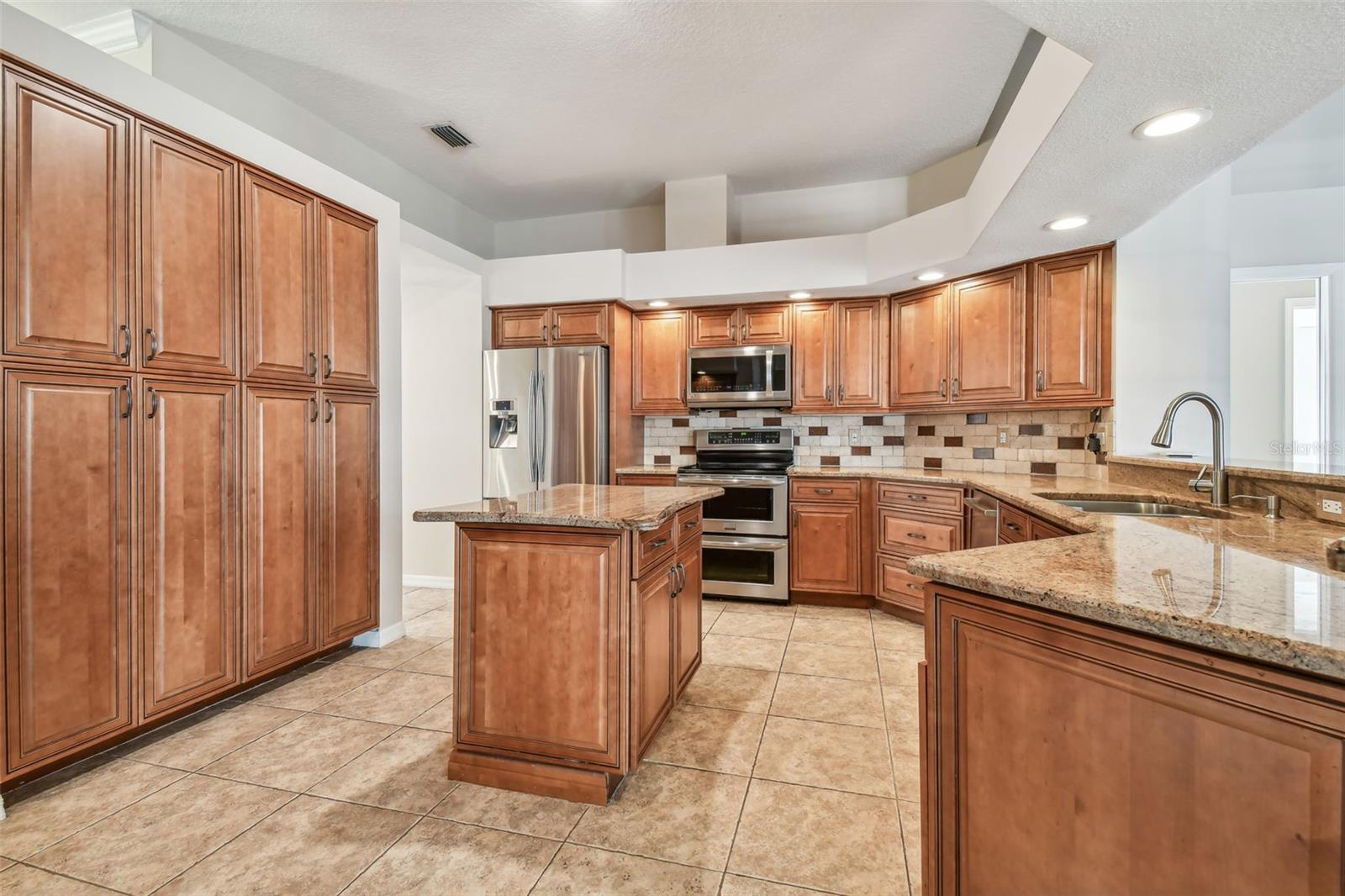 This kitchen is a chef's dream!  Stone countertops and solid wood cabinets.  Look at all the storage.