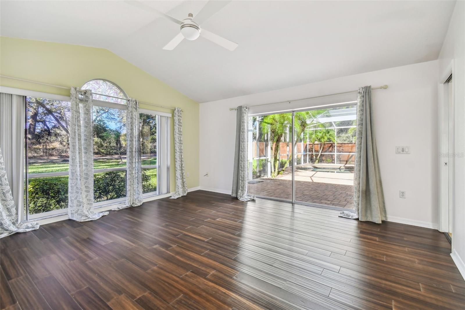 Bonus room with oversized windows that showcase the private backyard.