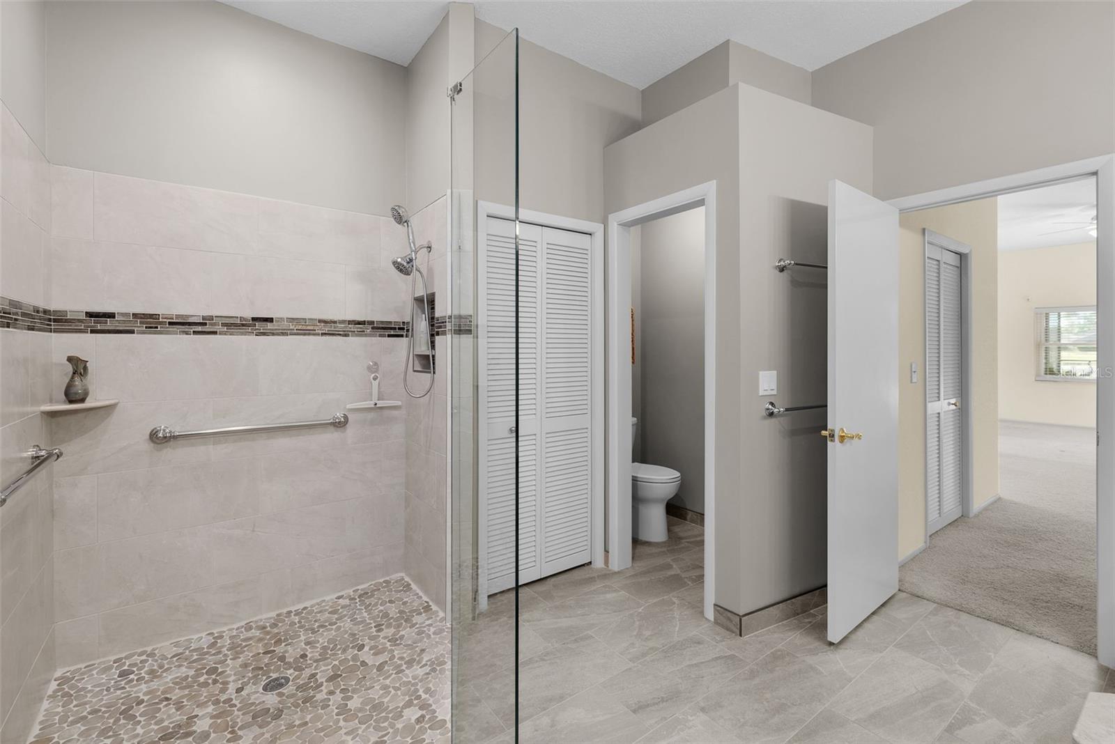 Remodeled Master bathroom with seamless glass walk in shower and private lavatory