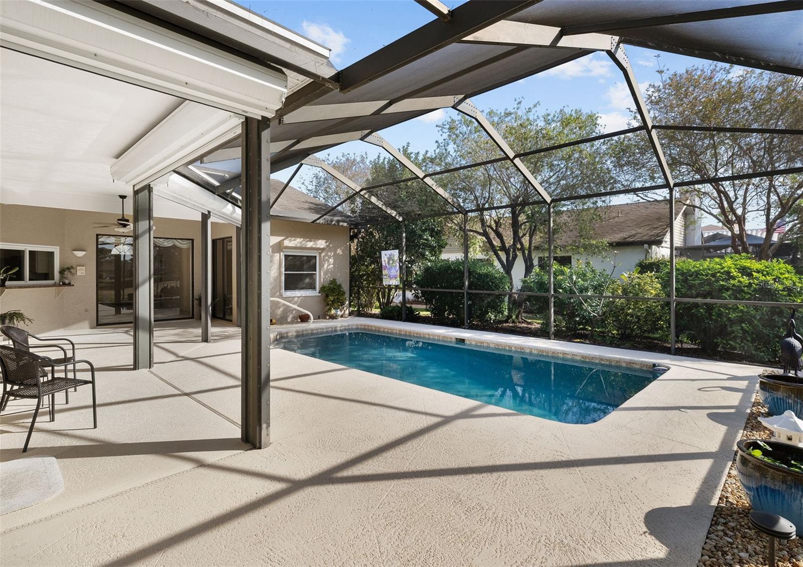 Another view of large covered lanai, complete with  hurricane shutters