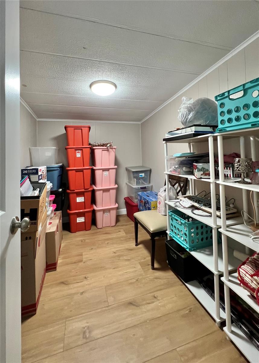 Large walk in closet can be inside laundry room.