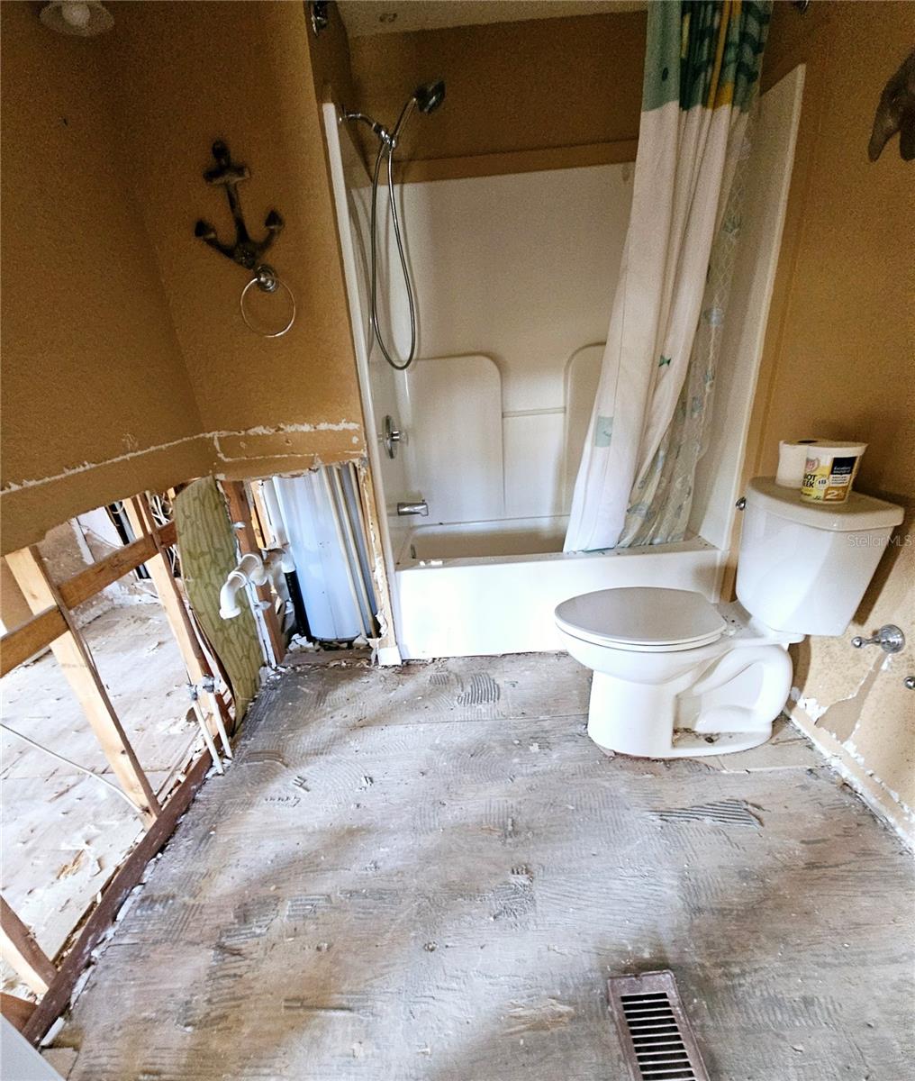 Main hallway bathroom. Tub/Shower & toliet still remain.