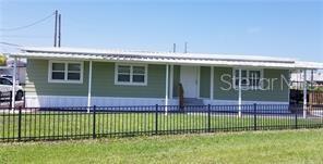 Side view of home. The entire yard is fenced in. Great for kids & pets!