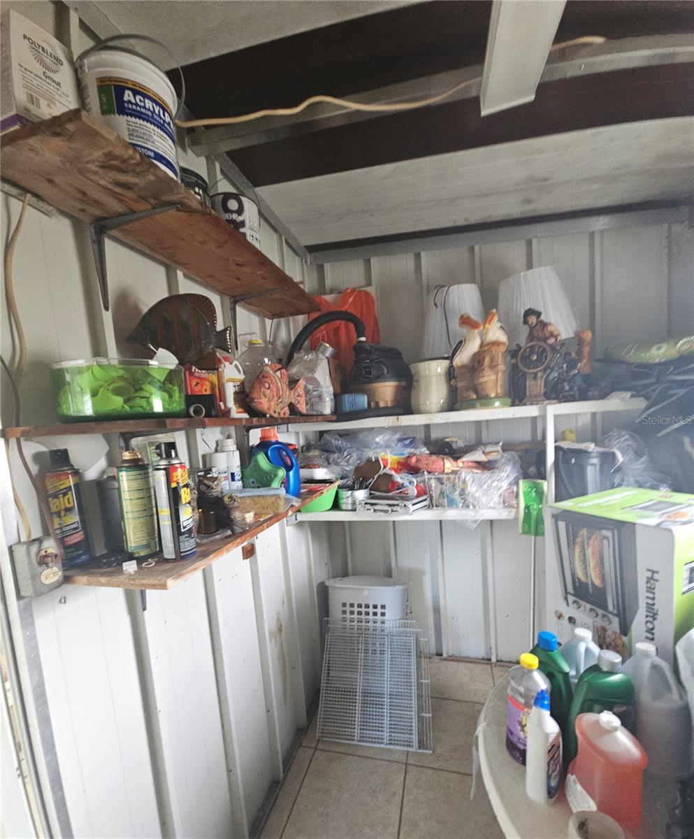 Shed located IN the Florida Room & where the washer & Dryer hook up is located.