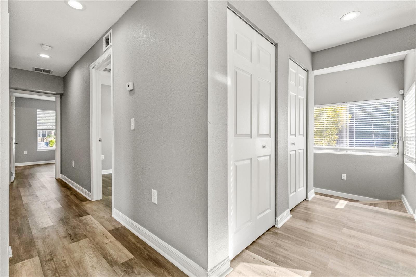 Upstairs hallway with full bath and two bedrooms on either side of the hall.