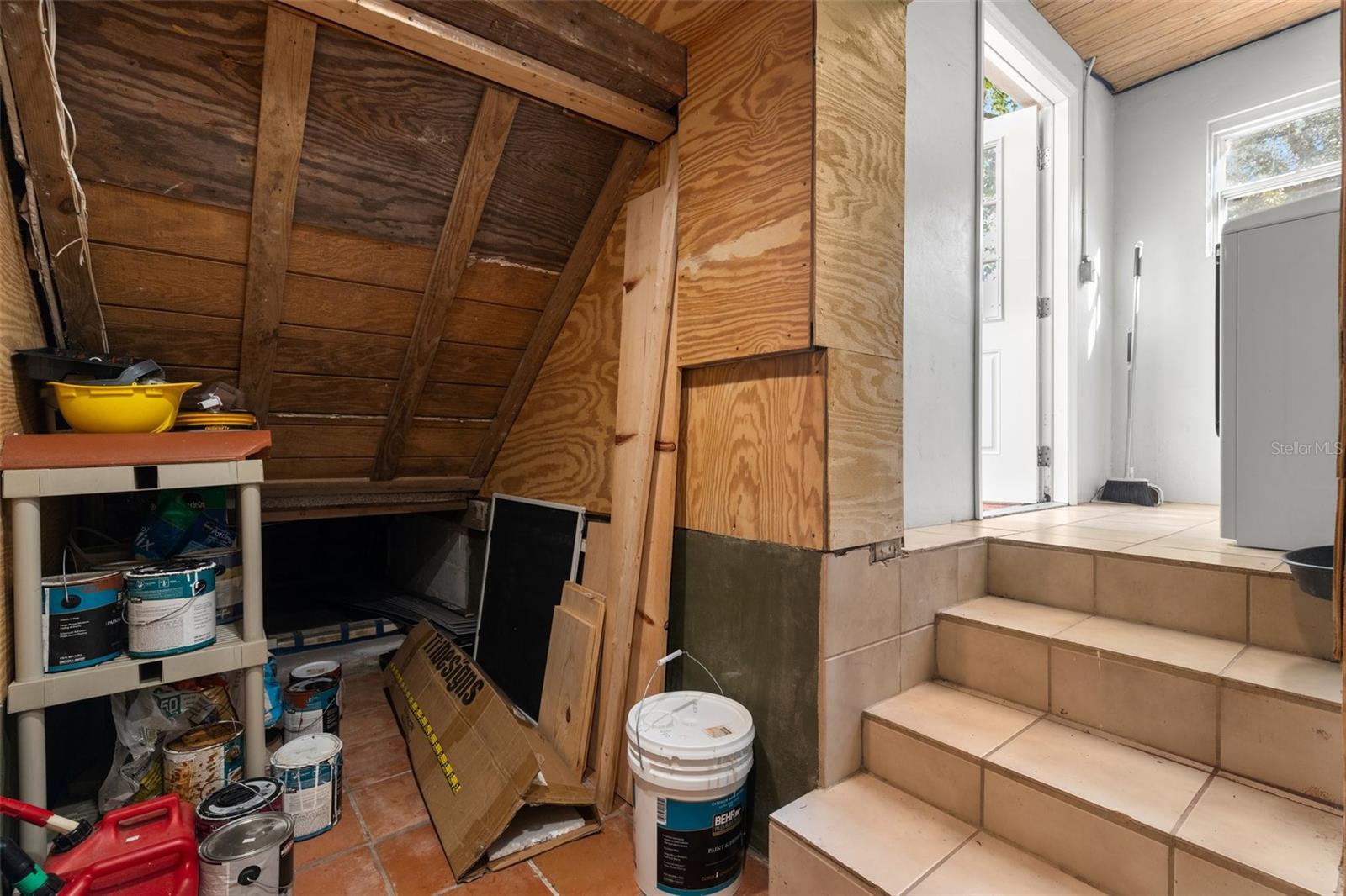 This is directly under the stairs in the house and connects with the laundry room.