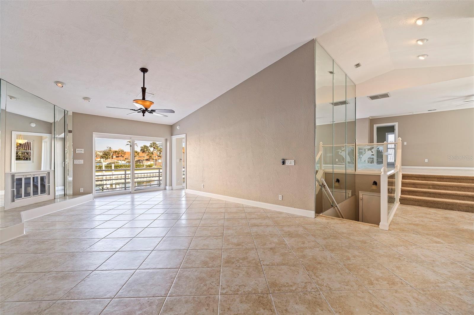 Main living area with views of family room, outdoor living area and downstair garage