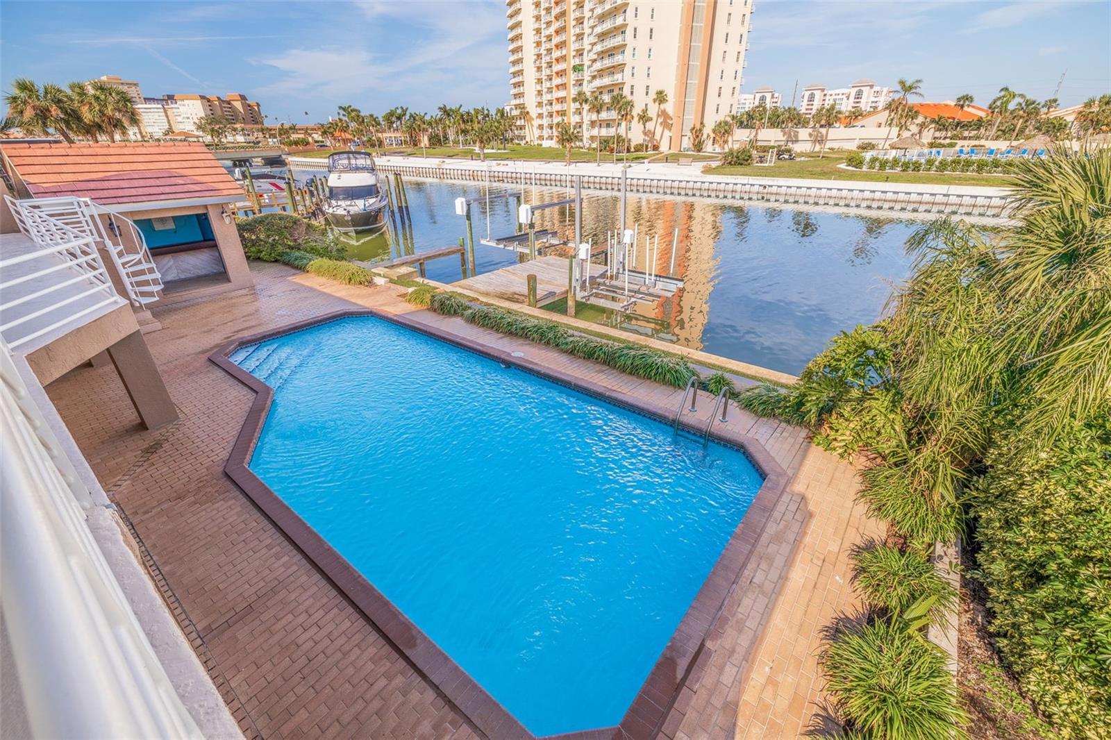 Sparkling pool and entertainment area with wooden cabana