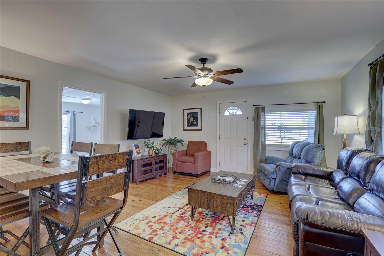 Front bedroom visible beyond dining table