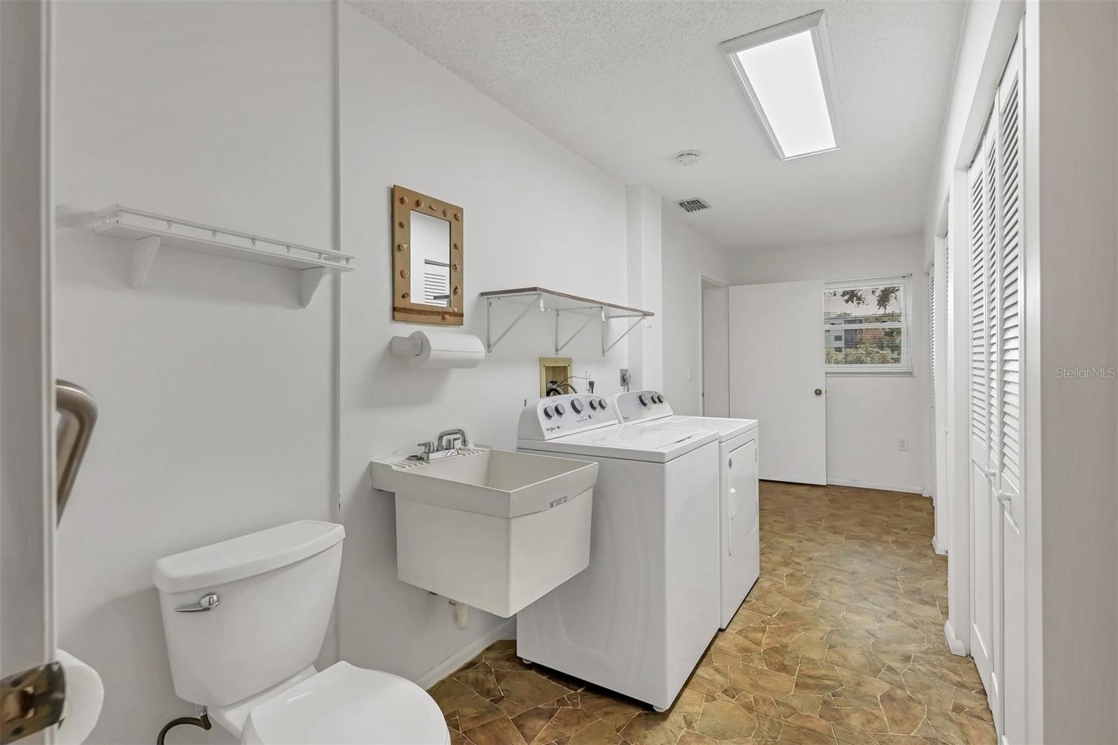 Huge laundry room off kitchen and bonus room with triple closets, utility sink and toilet.