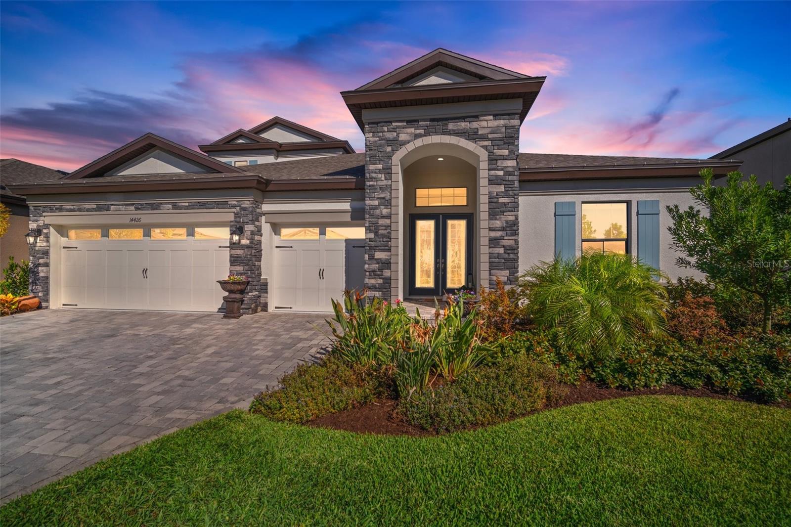 Evening Front Elevation with Brick Paver Driveway (digitally created evening view)