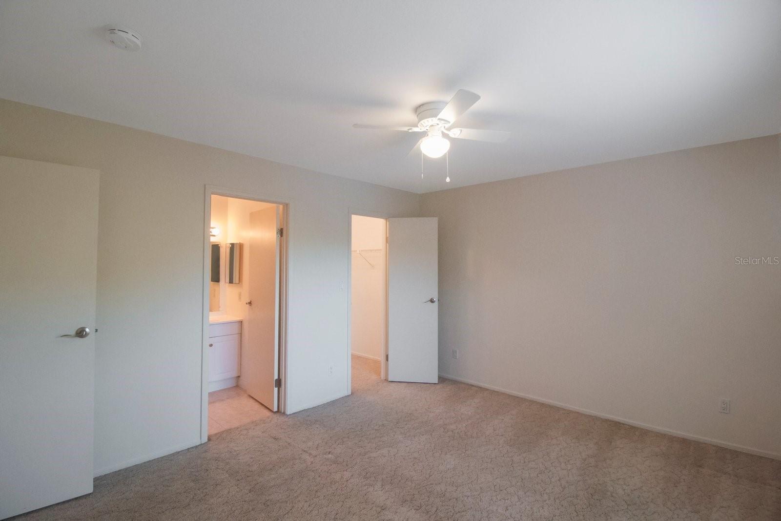 Guest bedroom with walk-in closet and en-suite.