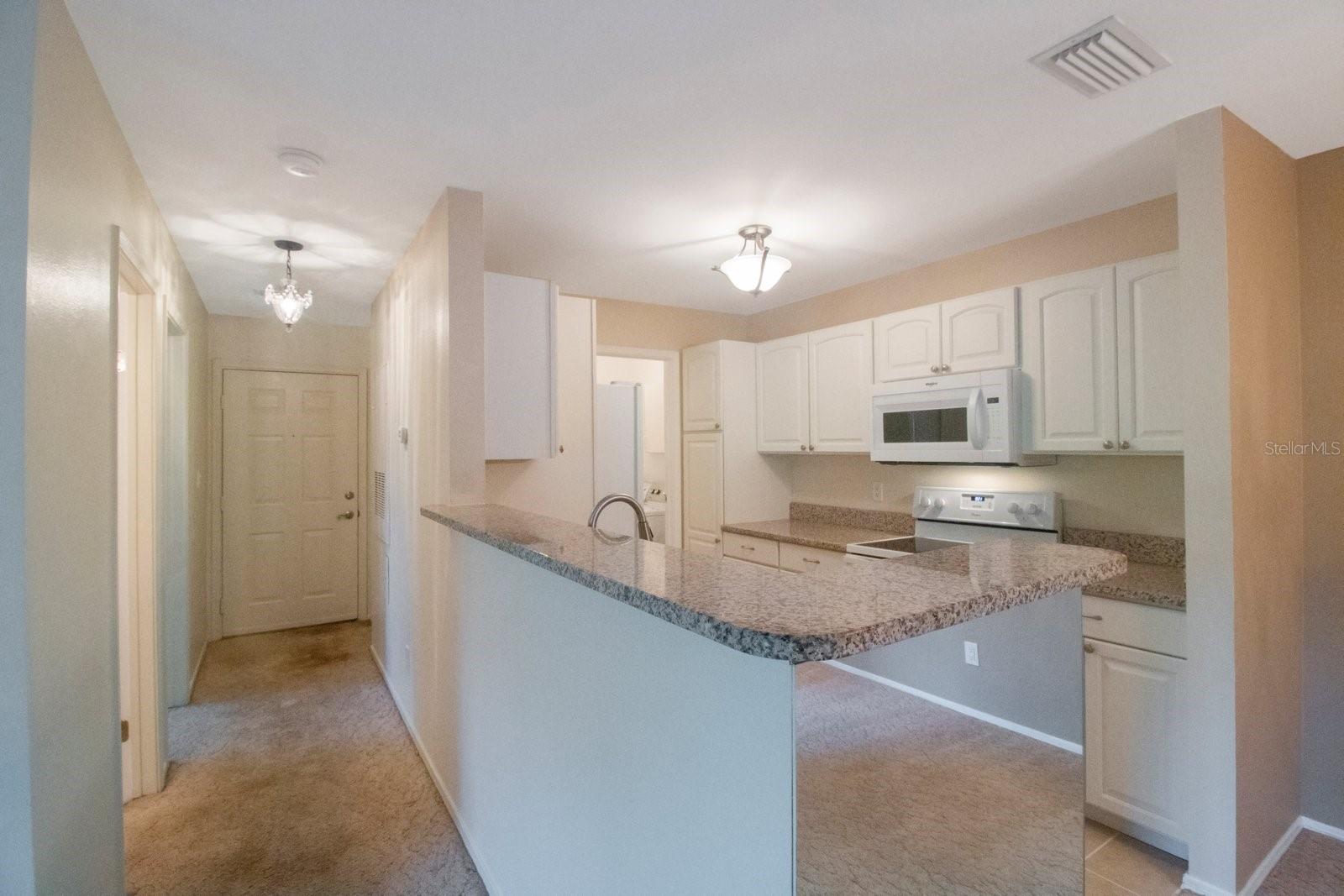 Open, light and bright kitchen with breakfast bar.