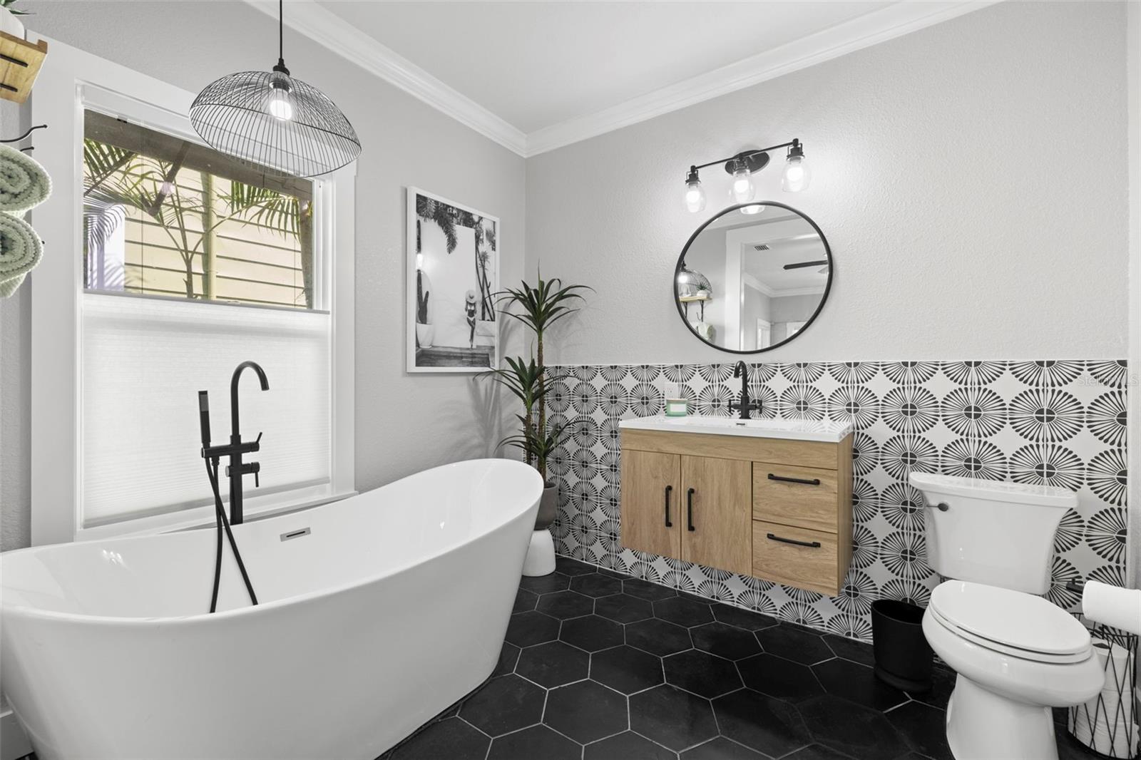 Who doesn't love an elegant tub and decorative tile?  This spacious and distinctive en suite bathroom is what dreams are made of...