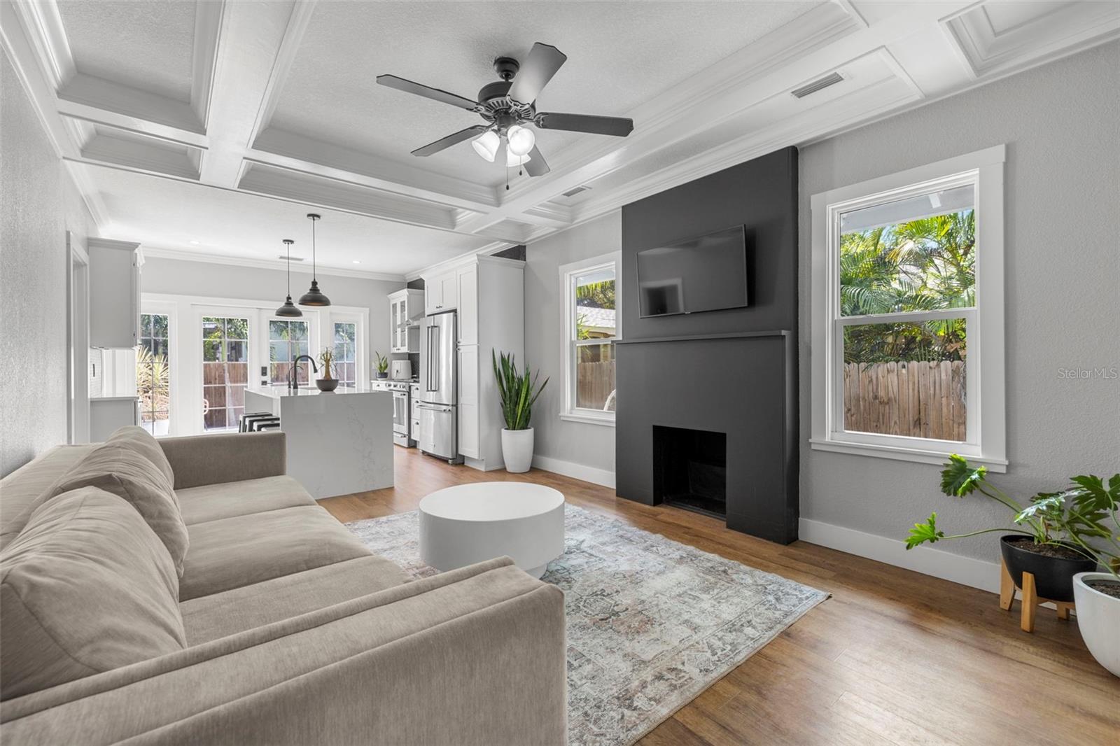 Spacious and beautifully updated living area with decorative fireplace and coffered ceilings.  St. Pete bungalow charm galore!