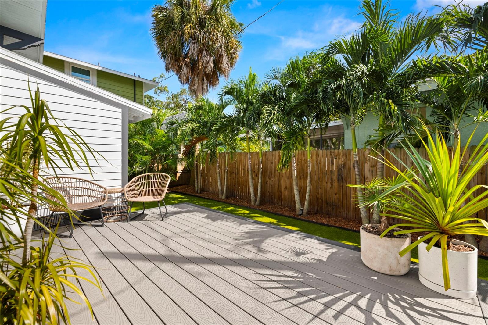 Your chill deck lined with palms and a privacy fence awaits...