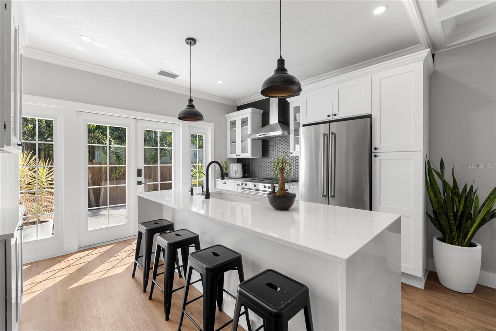 Completely updated kitchen with Whirlpool appliances (including gas range) and gorgeous waterfall island.  French doors let the light in and create a clean, crisp look.