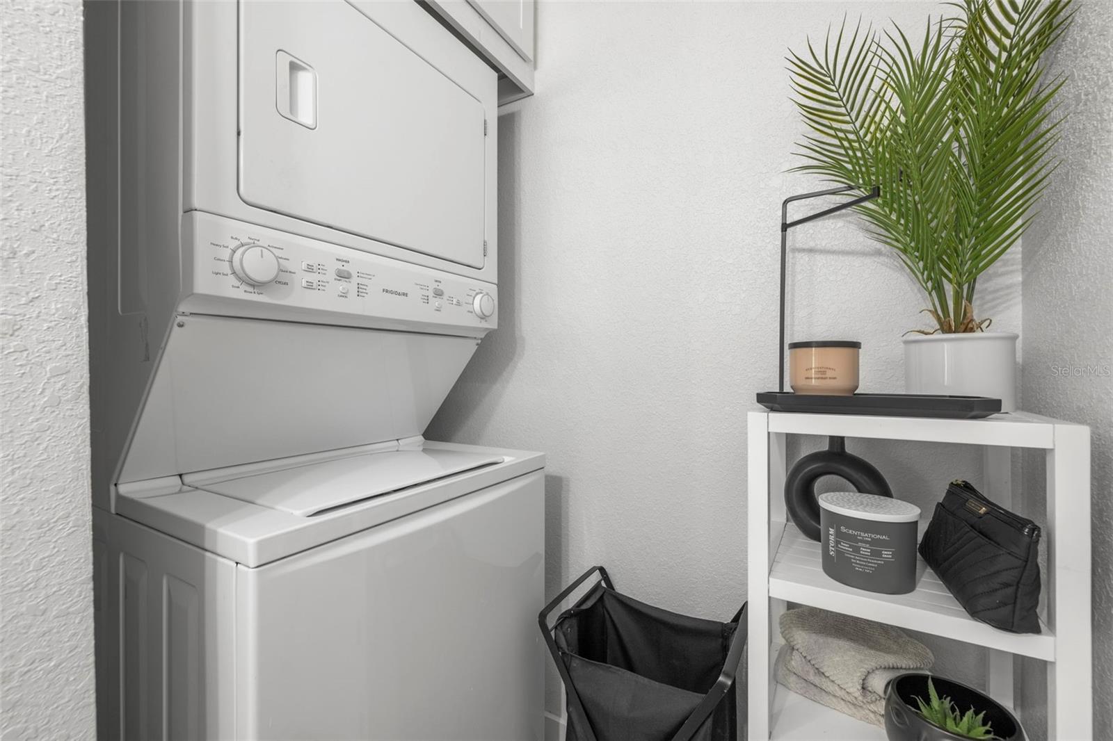 Full size, stacked washer & dry in a separate laundry room (just off the kitchen, with half bath) with an efficient use of space.