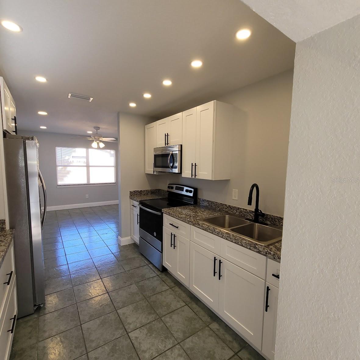 Double Sink, stove, and microwave, along with plenty of cabinets and counter space make this kitchen special.