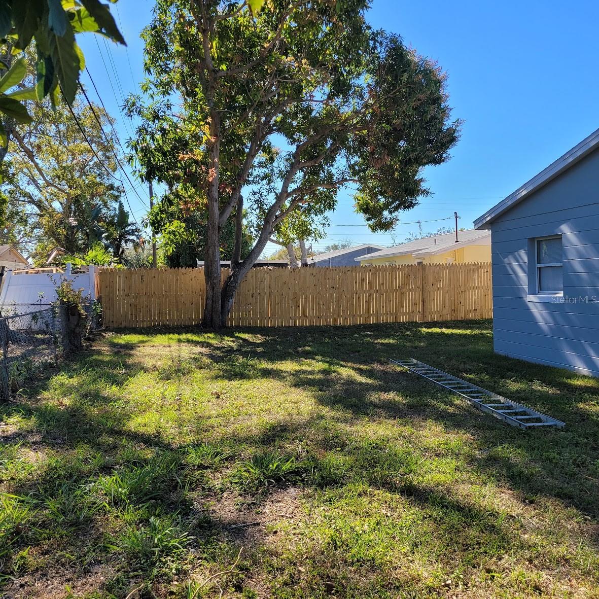 The large back yard is fully fenced, chain link to the left and nice wood fence straight ahead.