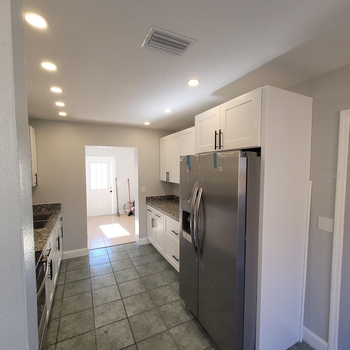 This view of the kitchen also shows the entry door from the driveway through the Family Room.