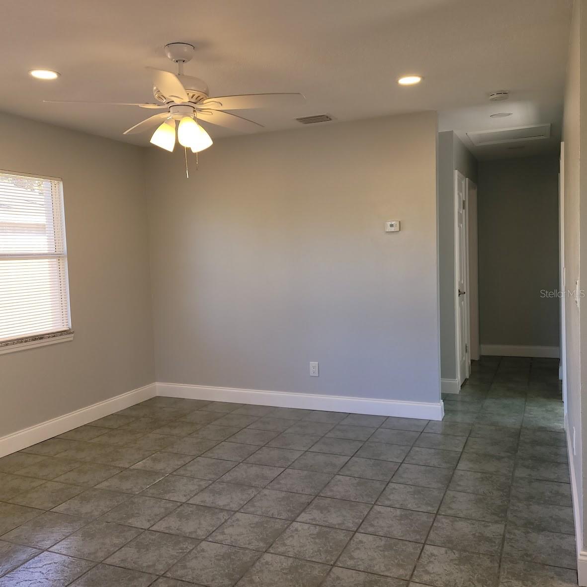 This 12X13 living Room is just off the kitchen and is the link to the 3 bedrooms and bathroom down that hallway.