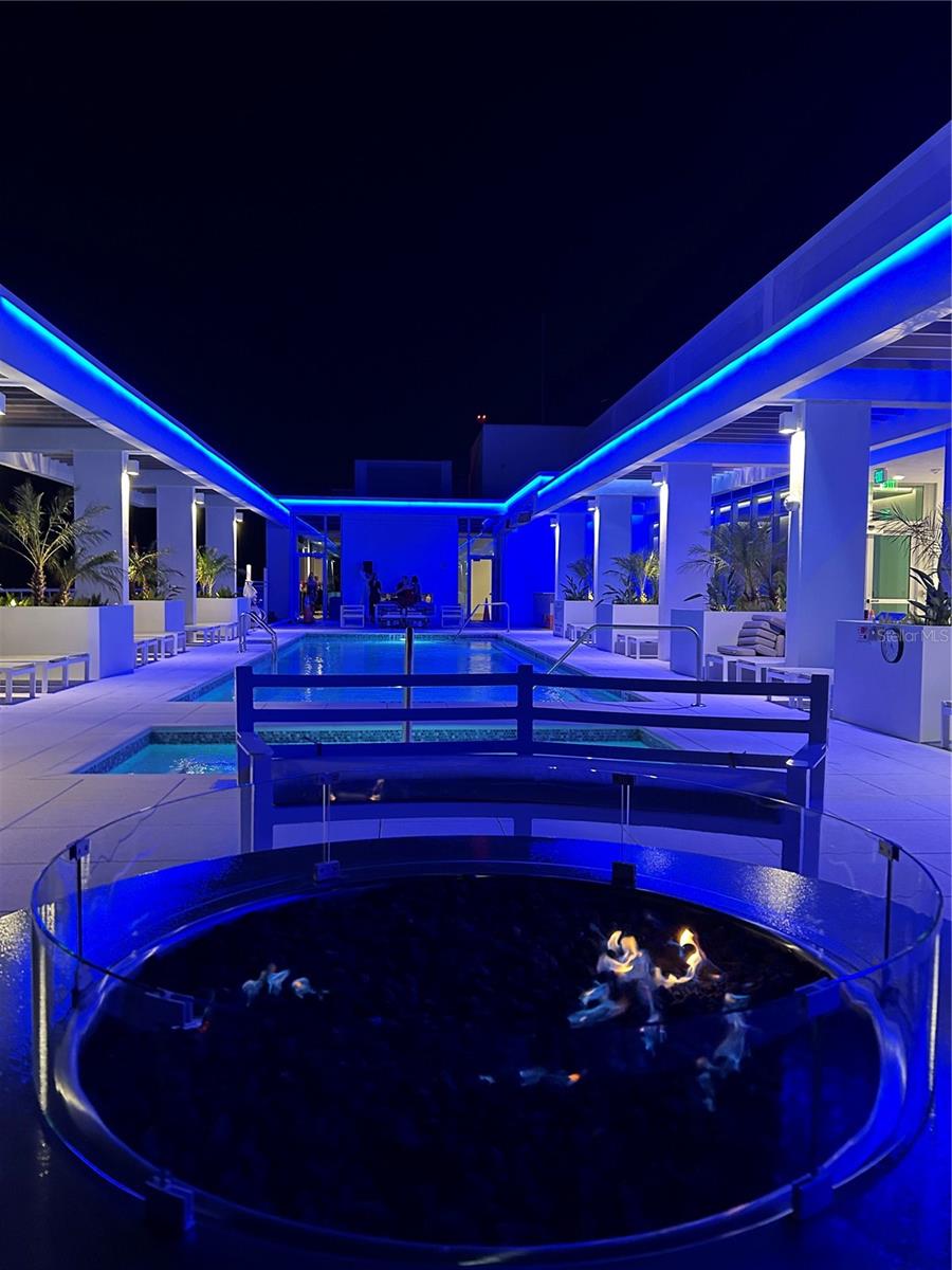 gorgeous night view of the pool and fire pit area