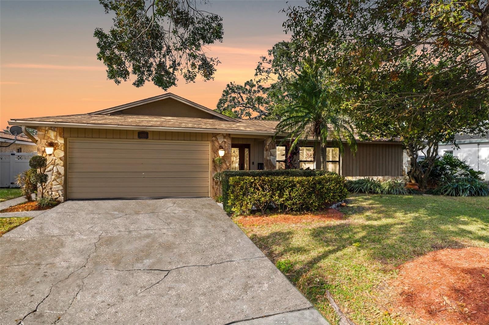 Mature oak accentuates the curb appeal and landscaping