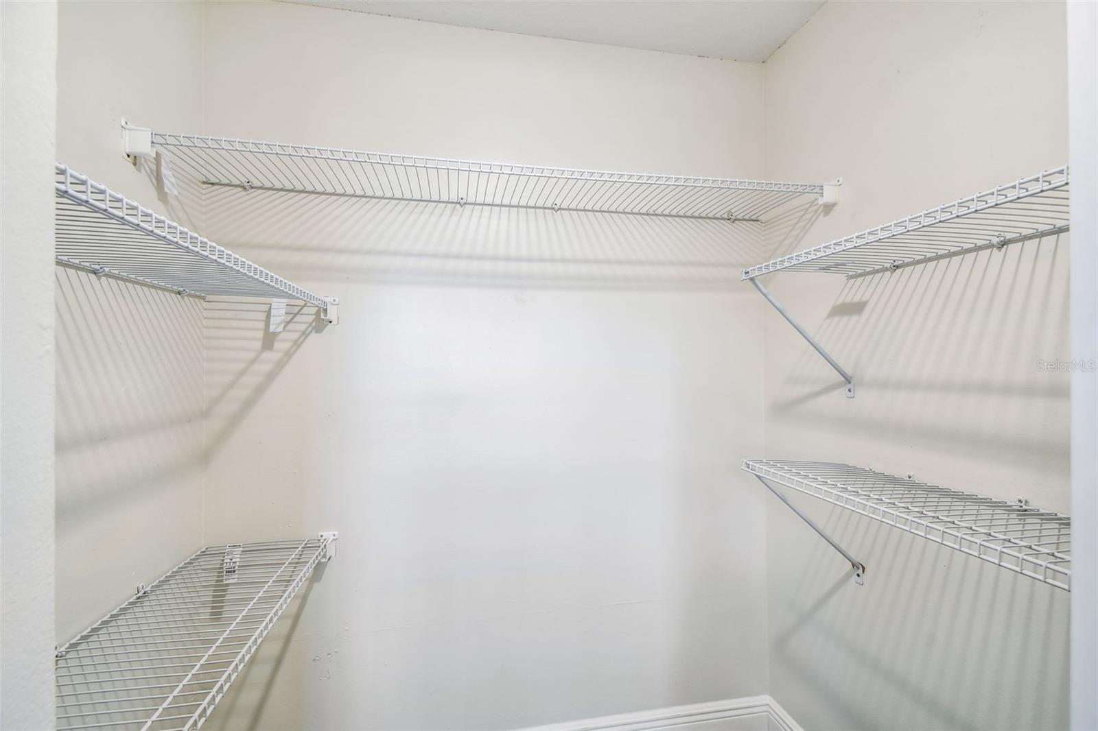 Large Closet with storage shelving in Bedroom 2