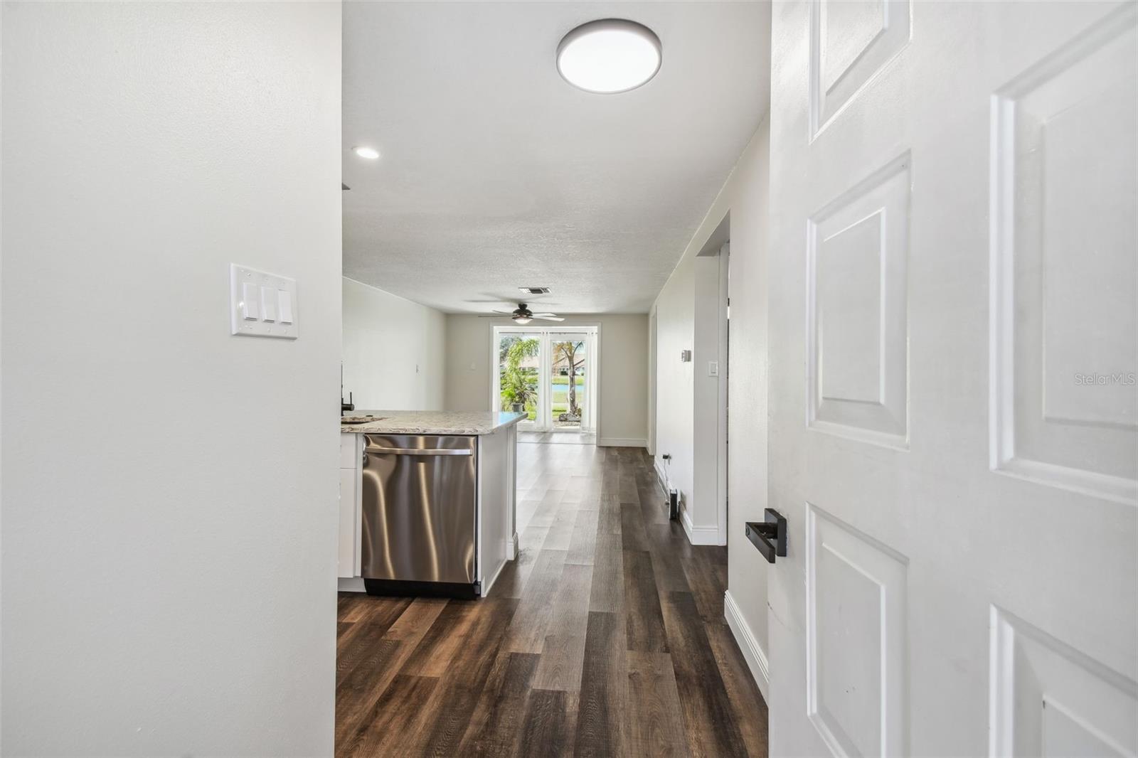 NEW LUXURY VINYL PLANK FLOORING THROUGHOUT, NEW KITCHEN WITH MODERN CABINETRY+HARDWARE, QUARTZ COUNTERTOPS, SS APPLIANCES, ADDITIONAL DRY GOODS PANTRY, LED LIGHTING, NEW HVAC, FRESHLY PAINTED INTERIOR.