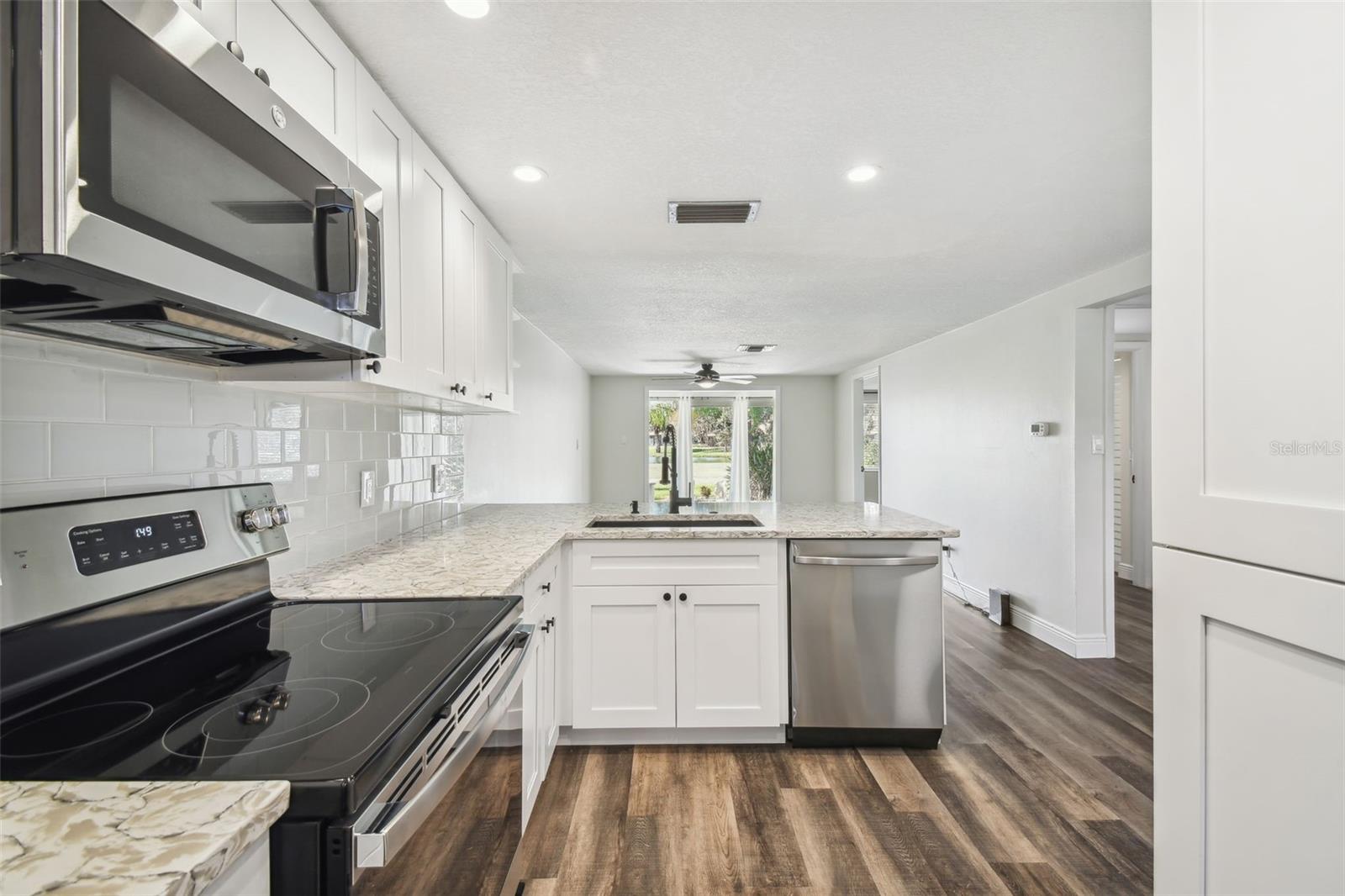 NEW LUXURY VINYL PLANK FLOORING THROUGHOUT, NEW KITCHEN WITH MODERN CABINETRY+HARDWARE, QUARTZ COUNTERTOPS, SS APPLIANCES, ADDITIONAL DRY GOODS PANTRY, LED LIGHTING, NEW HVAC, FRESHLY PAINTED INTERIOR.