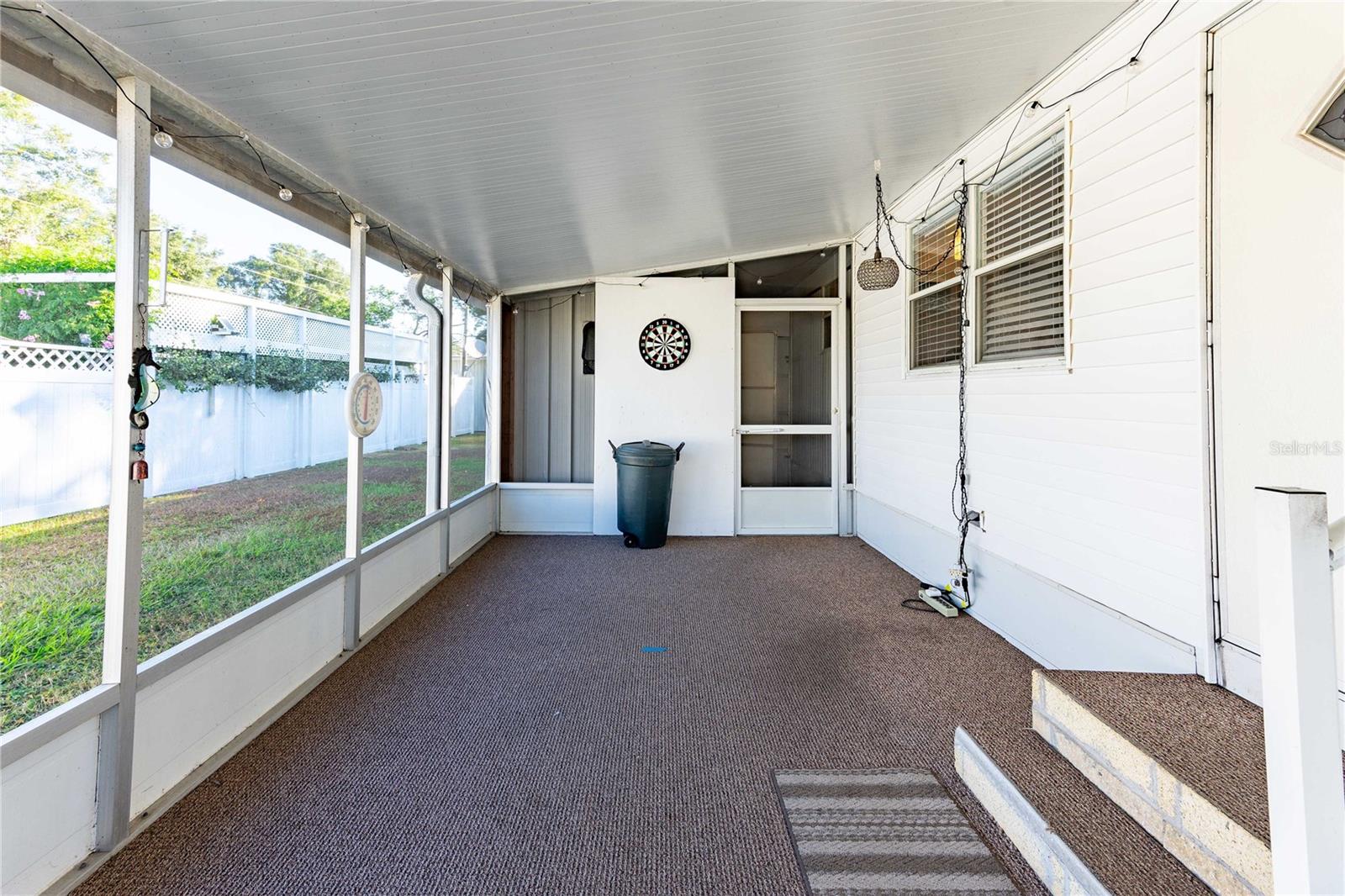 Screen room is off the carport.