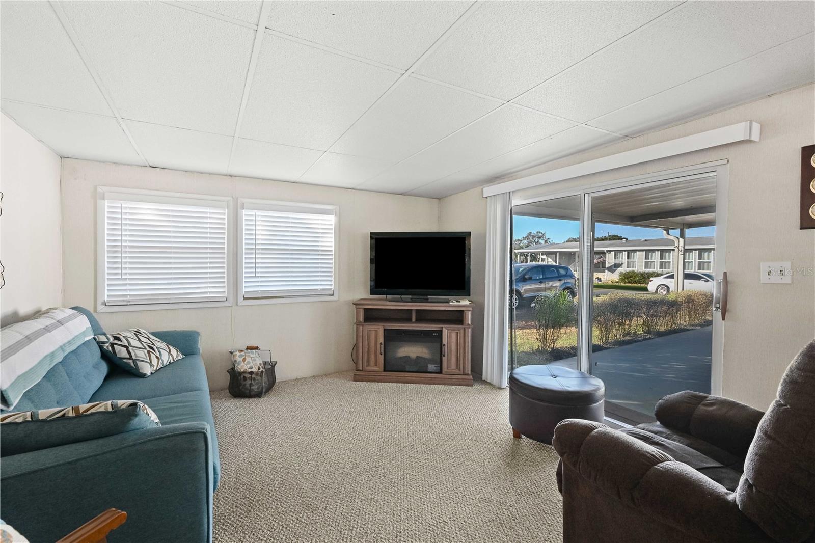 Living room has nice Berber carpeting.