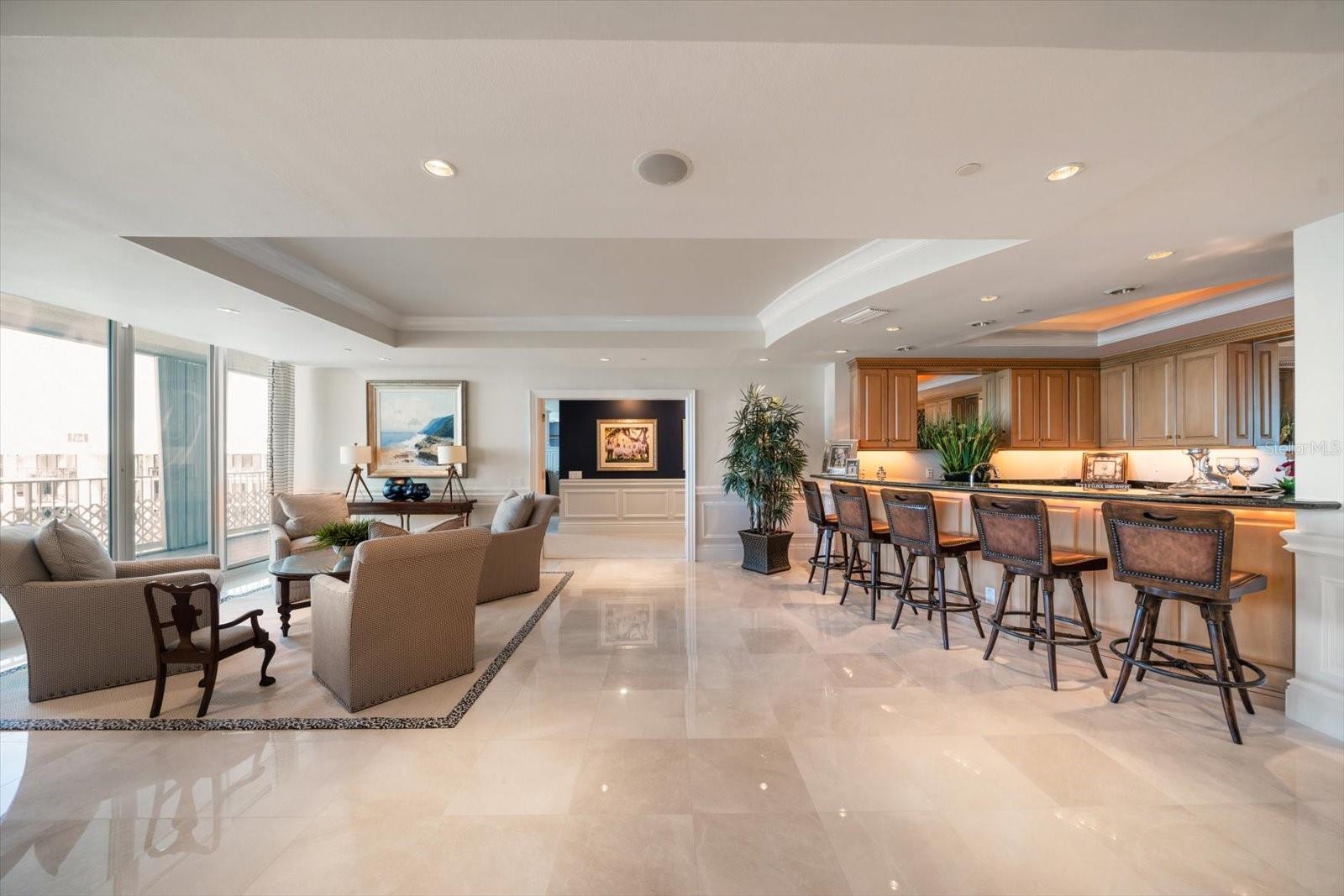 Entertain at the bar or in the sitting area, the floor plan provides abundant space for homeowners with varied interests.