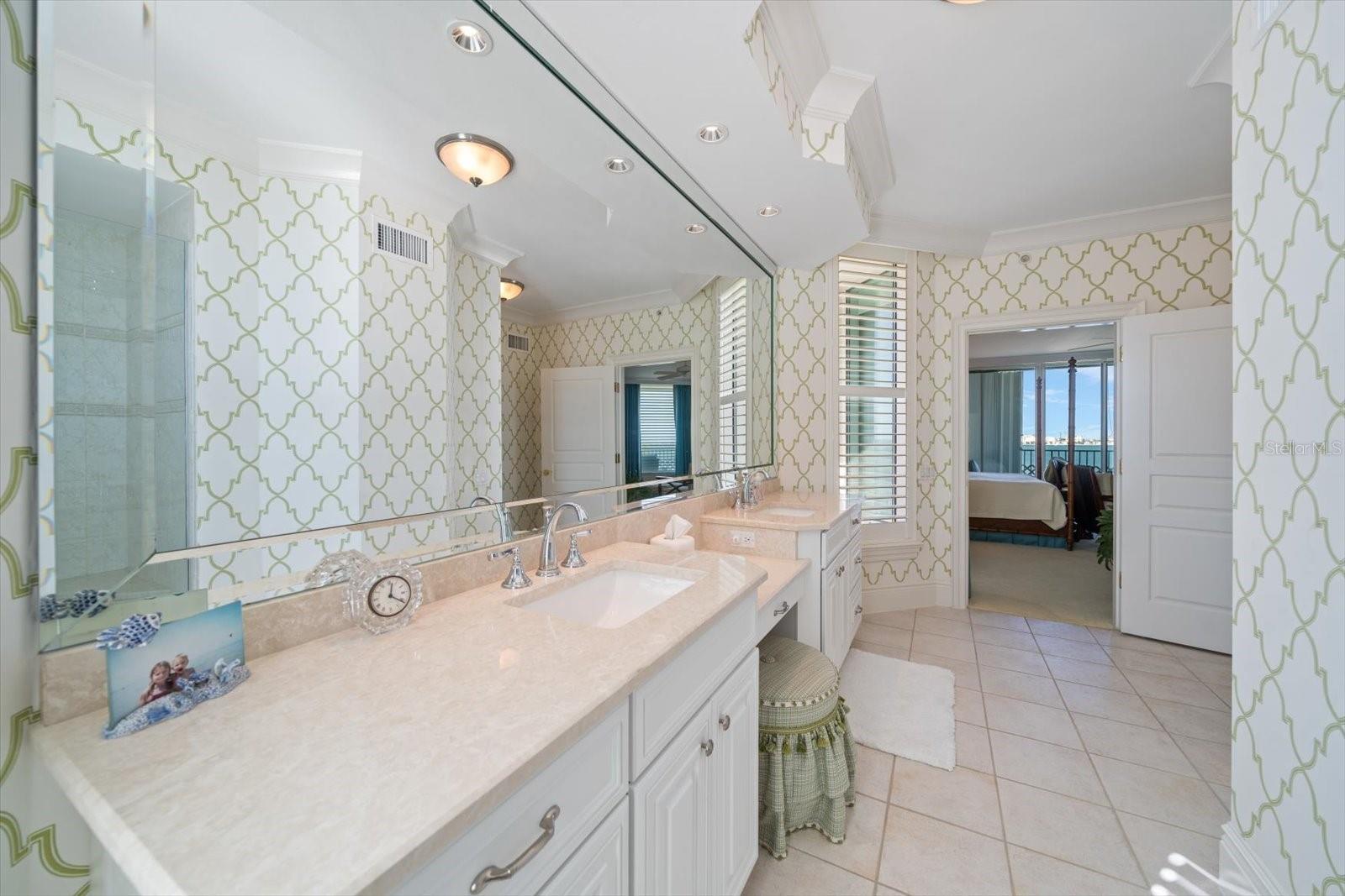 Ensuite guest bathroom area with double vanities and walk-in shower.