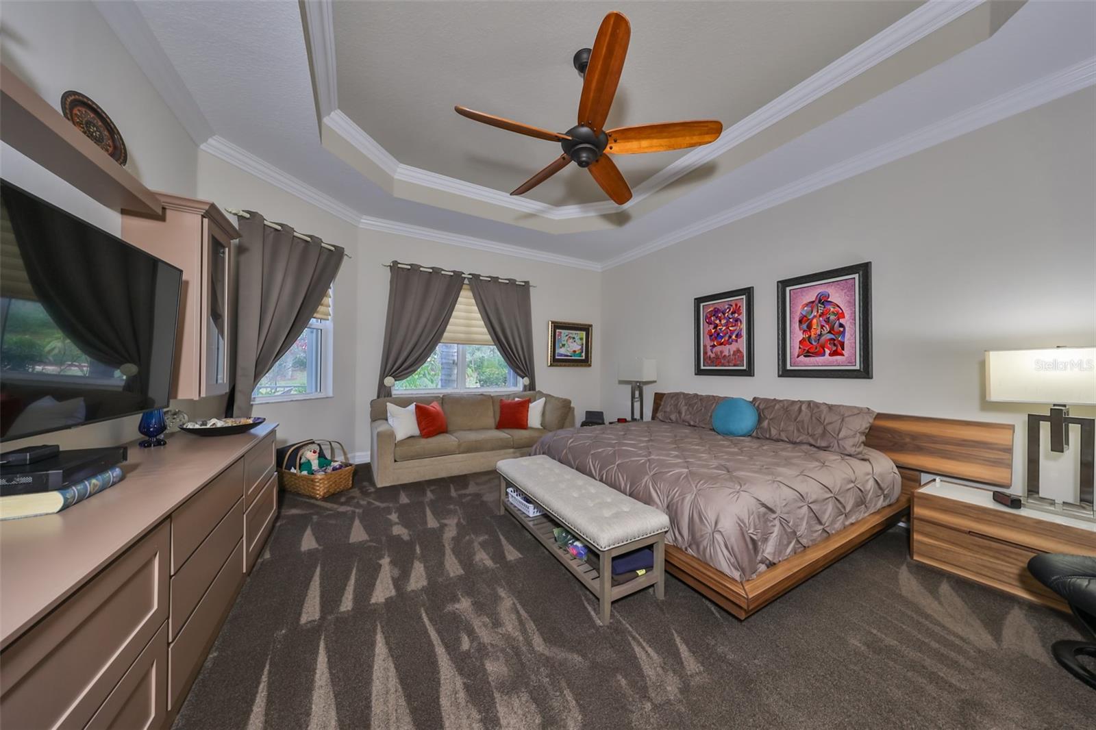 Primary suite with tray ceilings, Roman blinds and built-in dresser