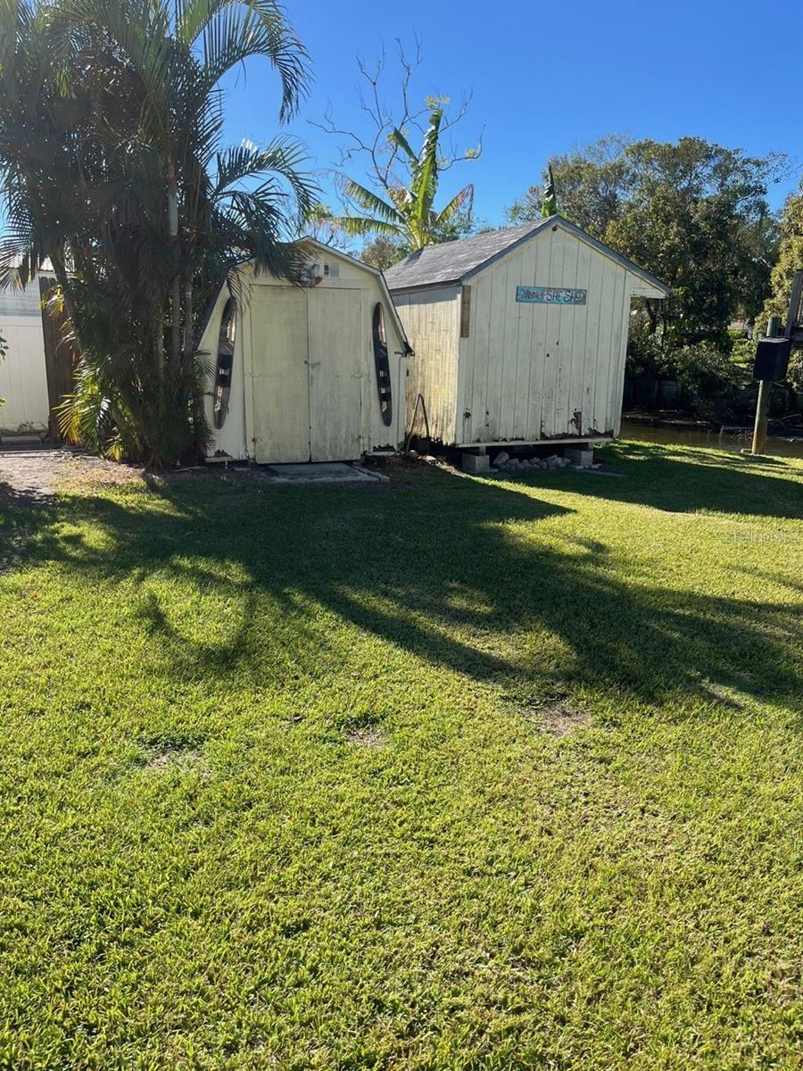 Back yard w/ 2 storage buildings