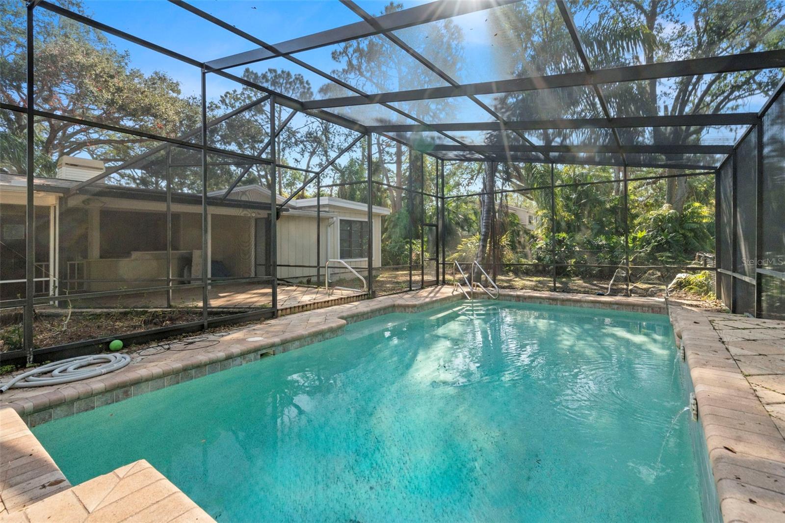 Pool with screened enclosure.