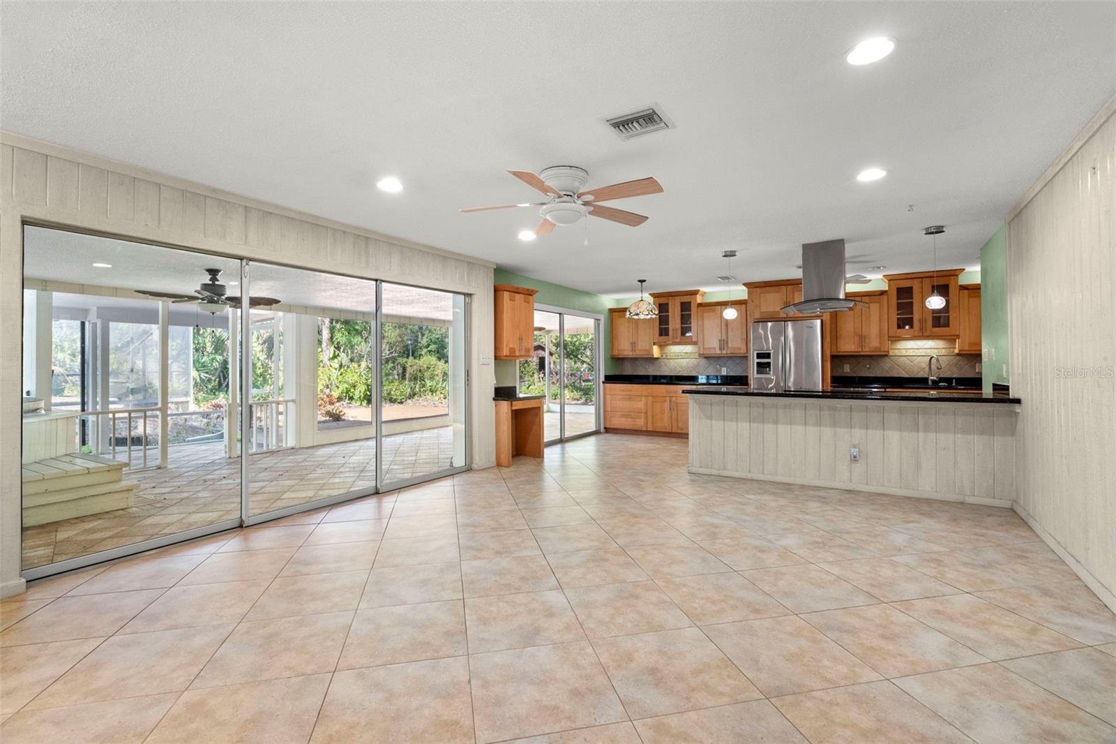 The living and dining areas connect to a well-equipped kitchen.