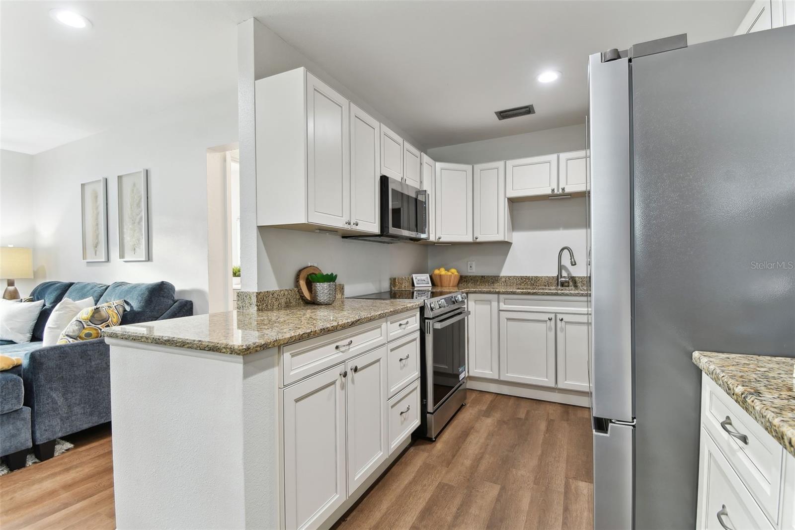 Antique White Wood Cabinets and Granite Countertops