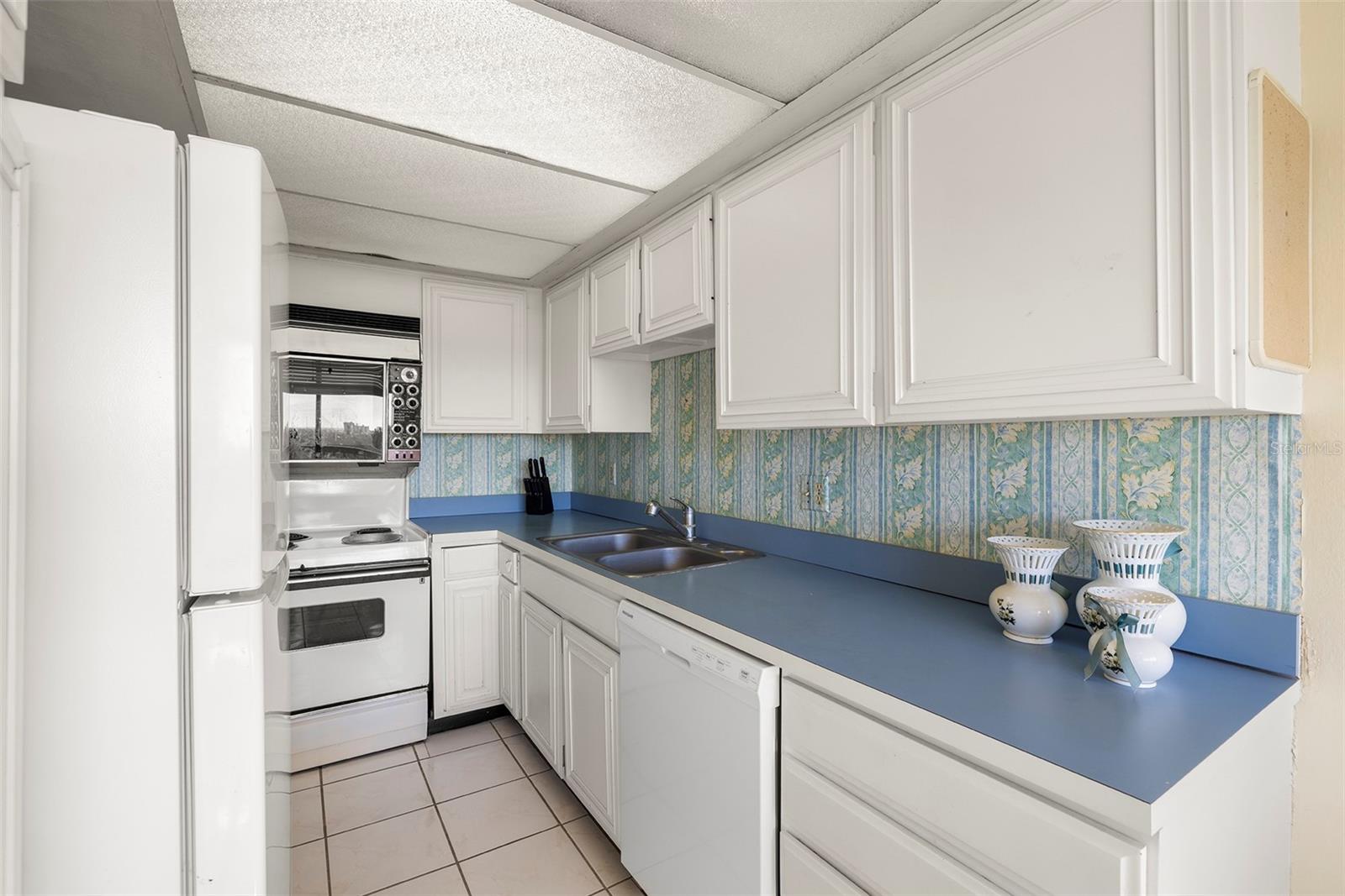 Functional kitchen layout with lots of storage and classic white cabinetry—ready for your personal upgrades