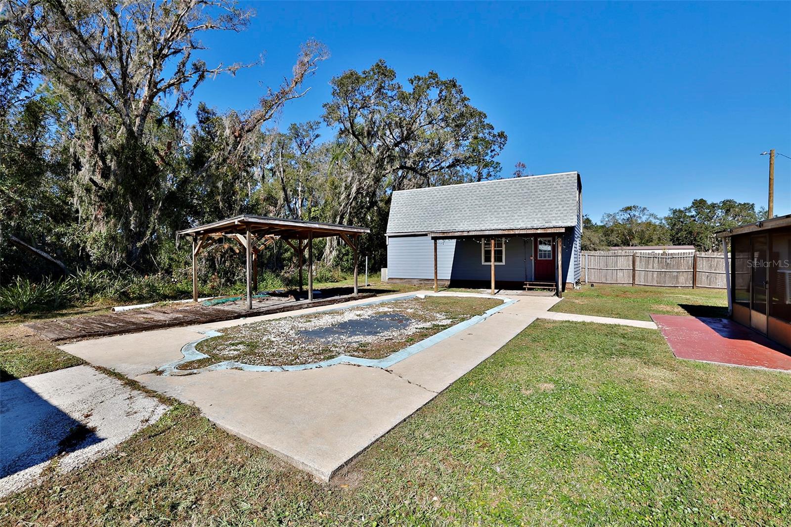 Previous in-ground pool, now filled in.