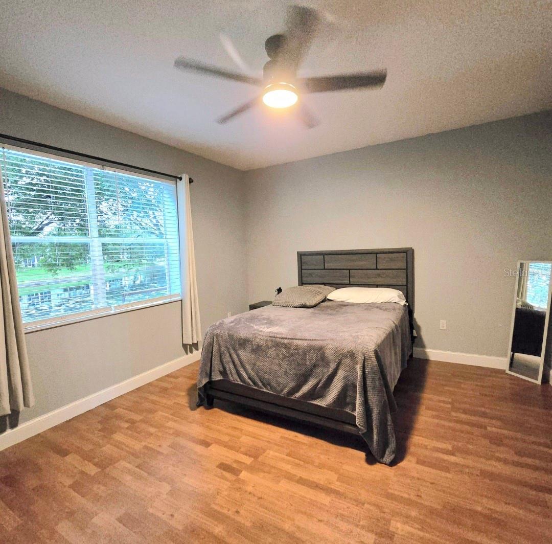 Large master bedroom overlooking pond