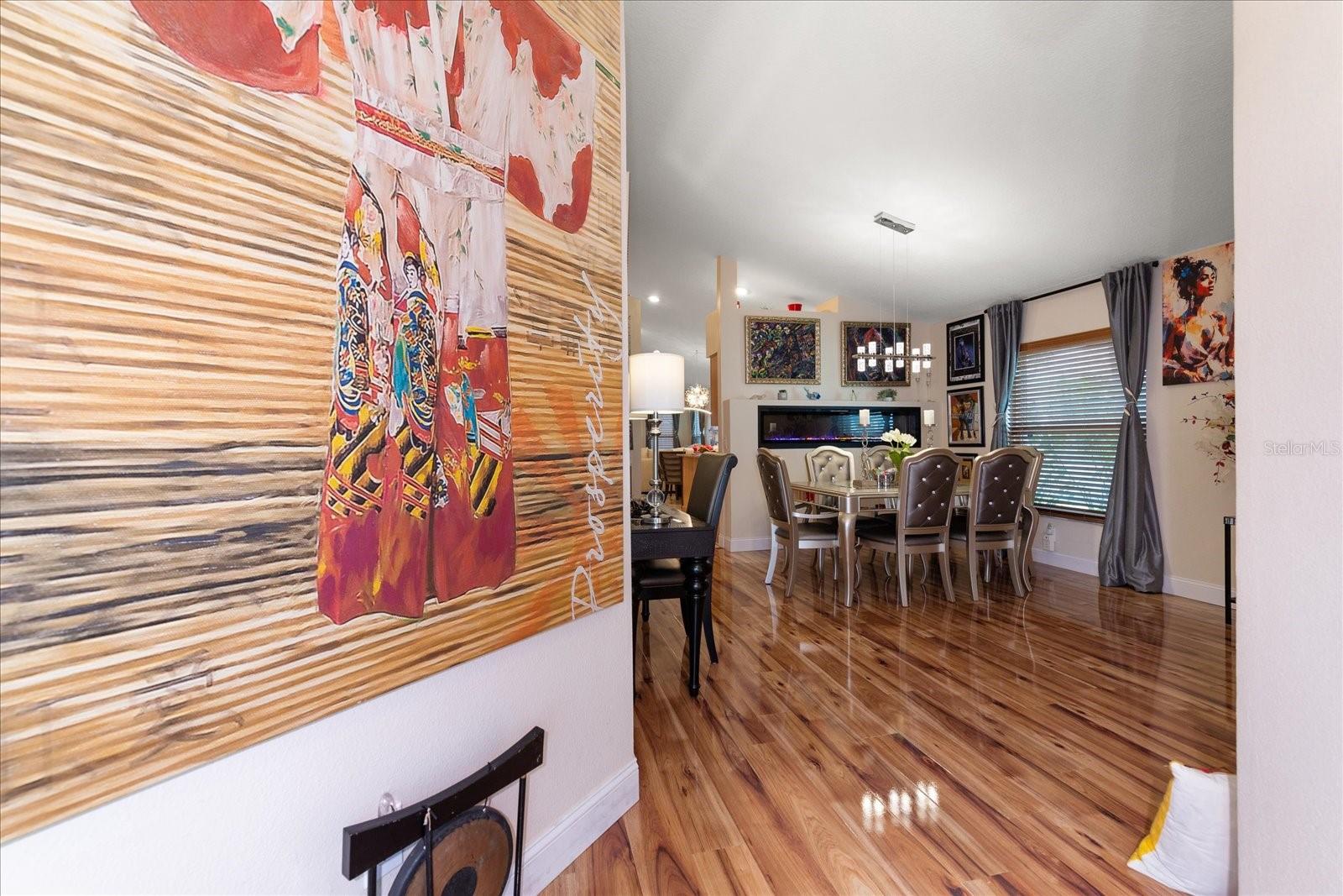 New Wood Glazed Floors as you enter and open up to Dining Room with mid wall Electric Fireplace