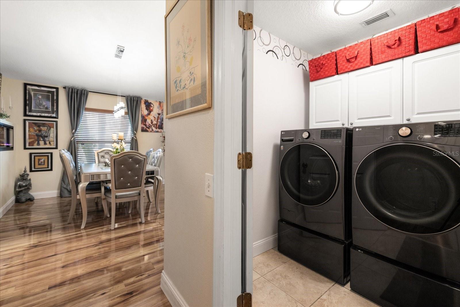 Nice Look of the Wood Glazed Floor and Laundry Room with LG Smart Washer and Dryer on Stand