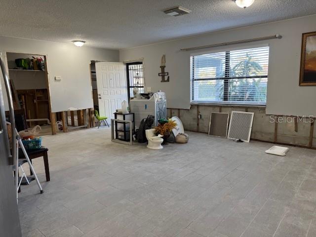 Living room and kitchen area view towards the front entrance