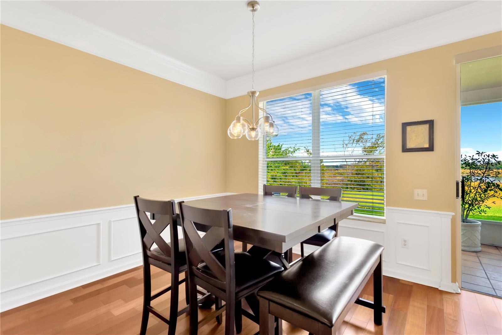 The dining area has a decorative Wainscoting with chair rail and crown molding for added interest and overlooks a private backyard with pond views.