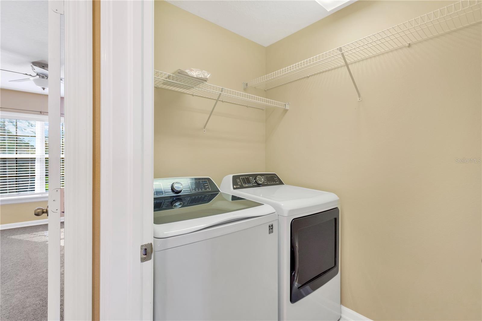 Upstairs Laundry room with GE Profile washer and dryer to convey to buyers.