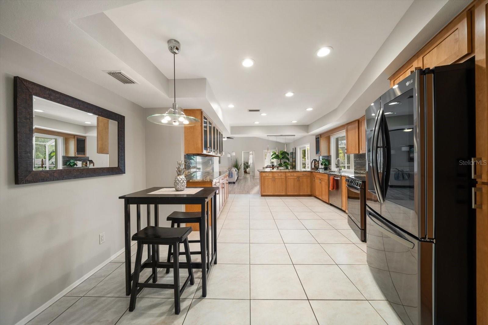 WOW! Love this kitchen with an eat-in area, breakfast bar, lots of cabinets and attractive granite-very attractive!